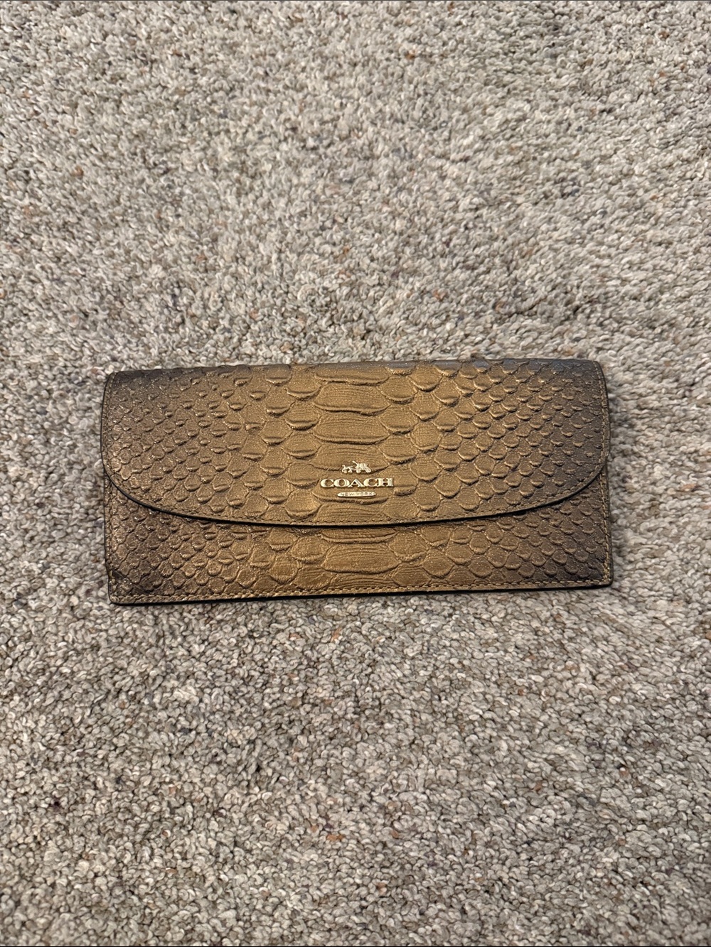 Coach Metallic snake-embossed leather envelope wallet in a muted gold tone